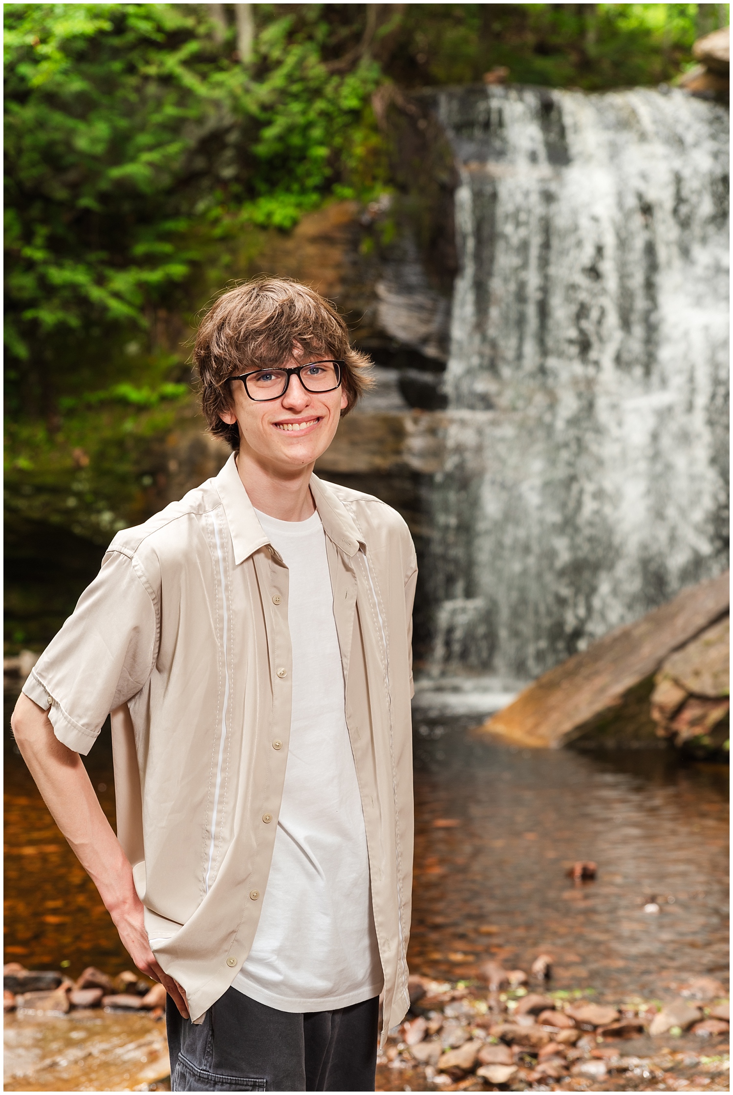 boy stands in front of popular keweenaw waterfall middle hungarian falls for senior photos