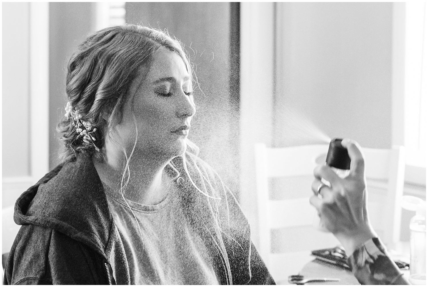 raes of beauty sprays makeup setter on bride after makeup