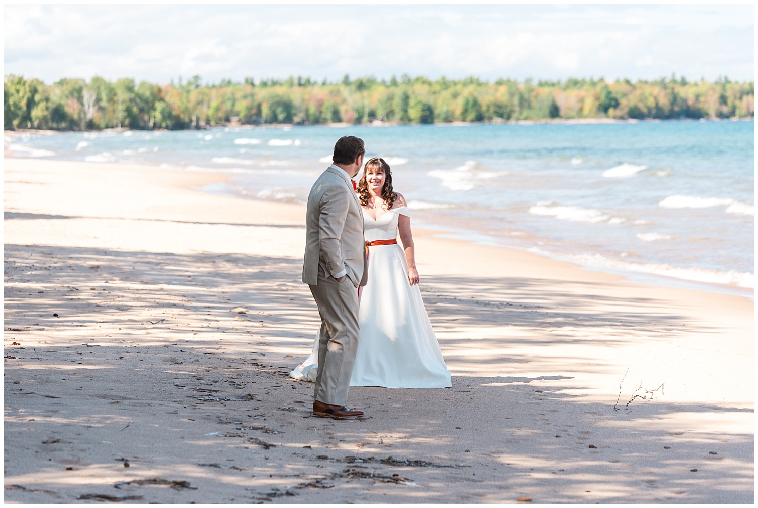 bride and groom first look on beach near lake superior